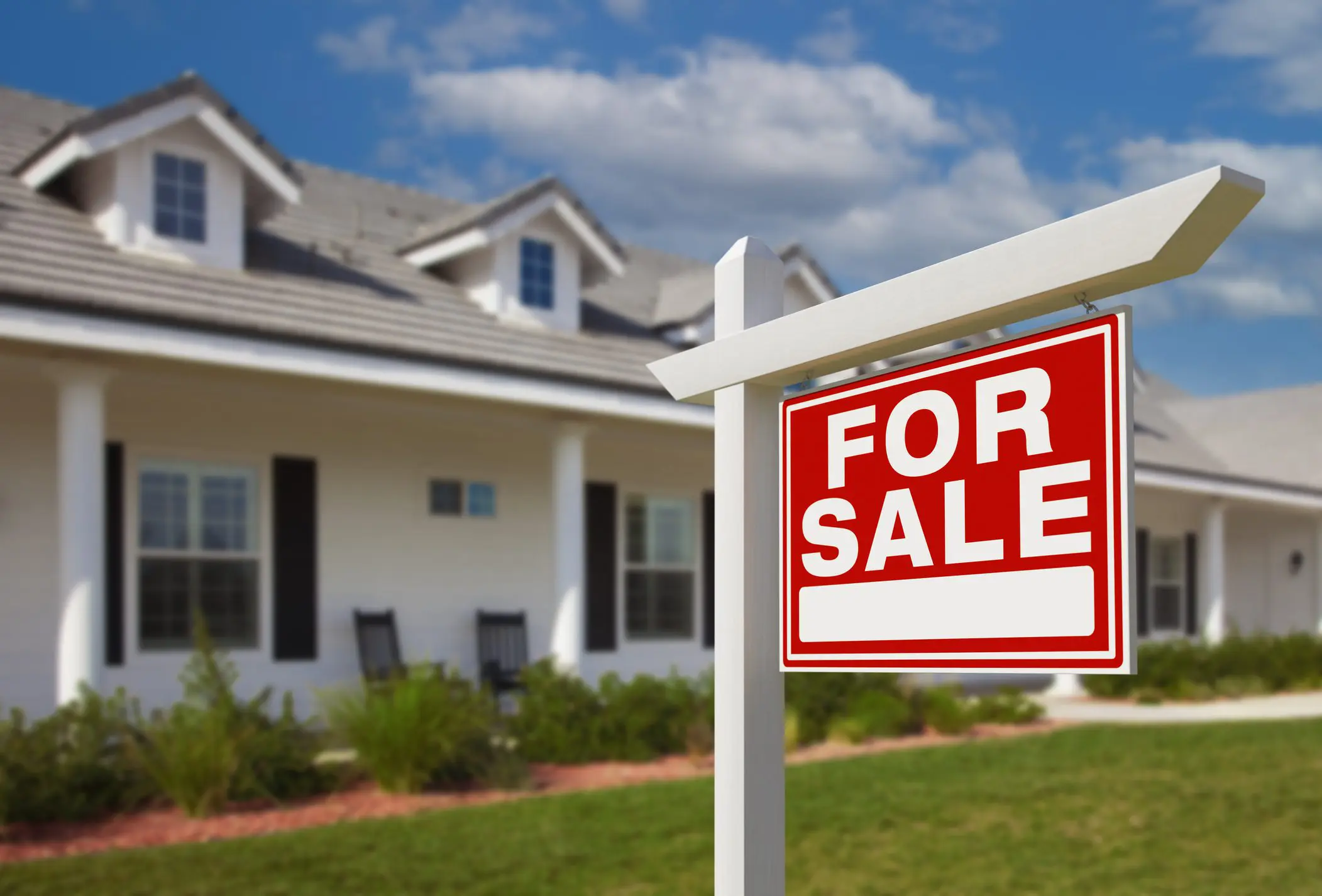 House with "For Sale" sign in front.